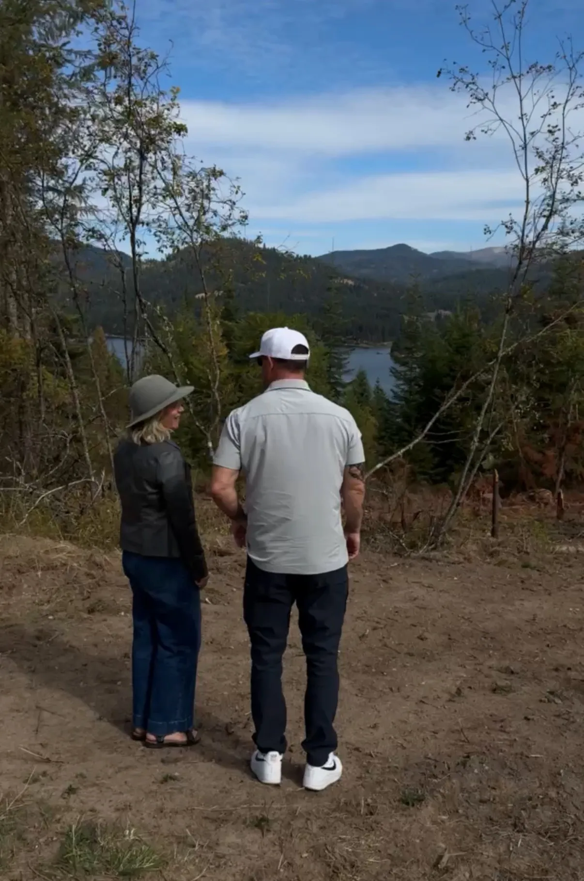 Jared Ban standing with a client on an open lot, the pair of them looking out across the land