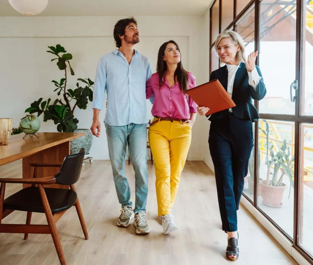 Realtor showing couple a modern apartment