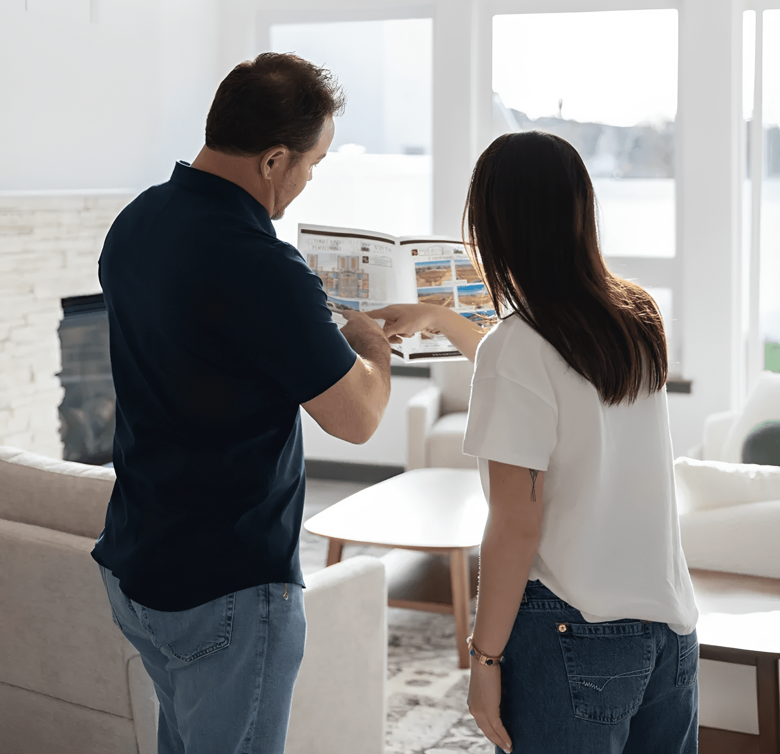 Two people reviewing a magazine together.